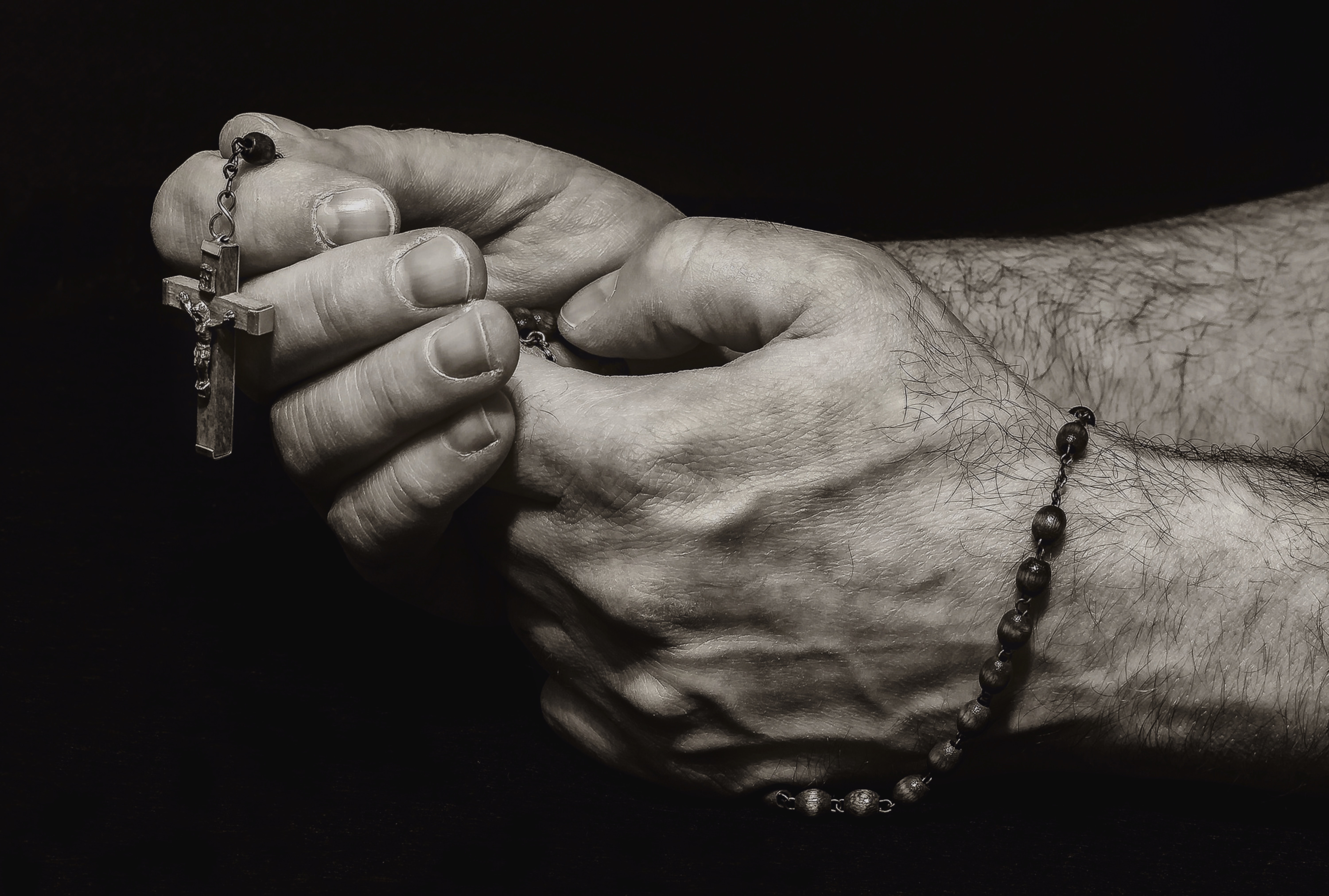 rosary on hand sephia photo by Myriam Zilles