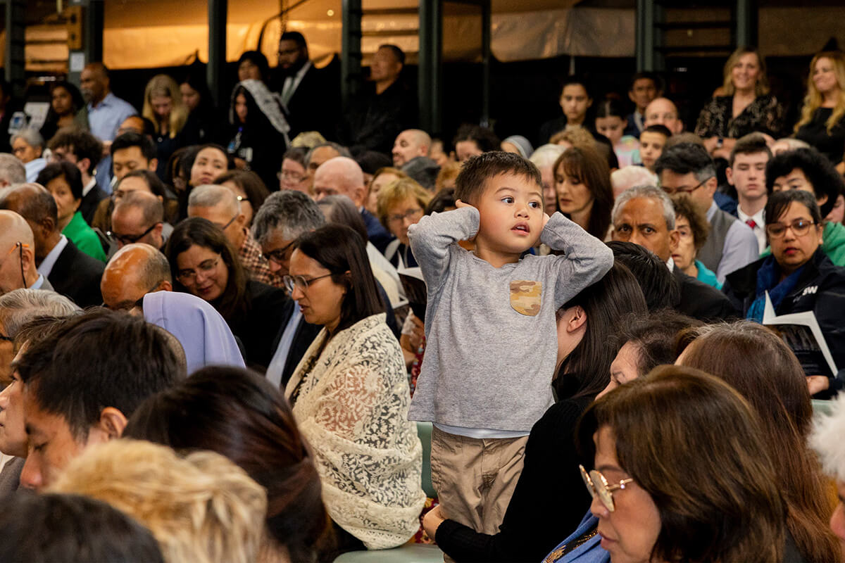 Diverse parish community gathered in modern church hall
